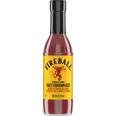 Weber Fireball hot sauce bottle on grill, ideal for bold wings and ribs.