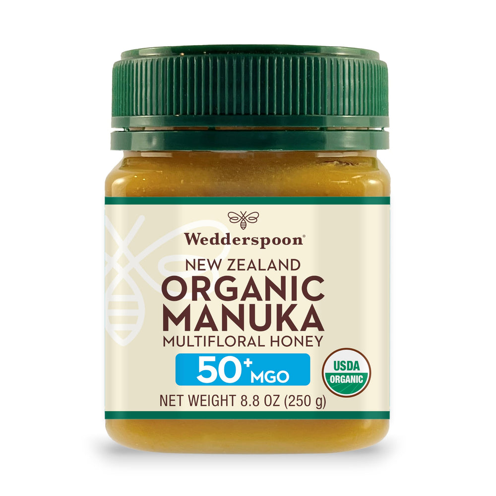 Wedderspoon Manuka honey jar close-up shows organic 50+ MGO richness for daily wellness.