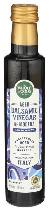 Whole Foods Market aged balsamic vinegar of Modena bottle with rich color for finishing dishes.