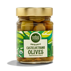 Whole Foods Market Organic Castelvetrano olives in a jar, showcasing vibrant green color and quality packaging.