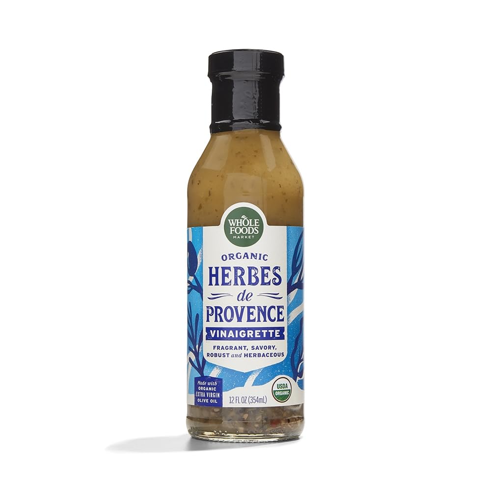 Whole Foods Market Organic Herbes de Provence Vinaigrette bottle pouring over greens for fresh flavor