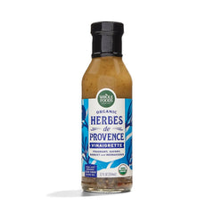 Whole Foods Market Organic Herbes de Provence Vinaigrette bottle pouring over greens for fresh flavor