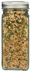 Pouring Whole Foods Market Spicy Sesame Garlic Crunch adds heat and aroma to a dish