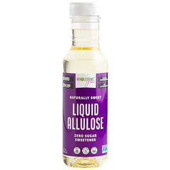 Wholesome Yum liquid allulose syrup poured from a bottle, zero calories.
