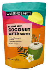 Wilderness Poets coconut water powder being poured into a glass for instant hydration.