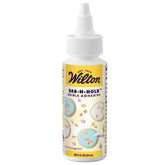 Wilton Dab-N-Hold bottle close-up showing clear edible adhesive for secure fondant.