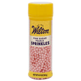 Wilton Pink Sugar Pearls elevate cakes with elegant pink sparkle.