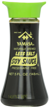 Yamasa Less Salt Soy Sauce bottle on a kitchen counter offers lower-sodium flavor for everyday meals.