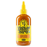 Yellowbird Organic Habanero Hot Sauce bottle on counter emphasizing bold flavor.