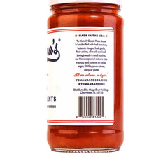 Pouring Yo Mama’s Foods Keto Classic Pizza Sauce for quick pizza topping.