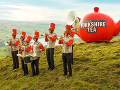 Yorkshire Tea red pillow tea bags being poured hot water.