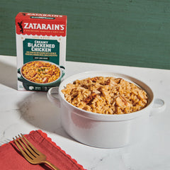 Creamy, cheesy rice with parmesan and romano alongside blackened chicken