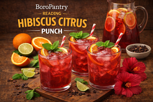 A chilled jug of Reading Hibiscus Citrus Punch filled with ruby hibiscus punch, ice and dehydrated orange slices, styled as a bright non-alcoholic sharing drink for the BoroPantry UK blog.