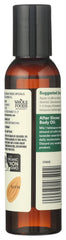 Close-up of the almond oil bottle with pour cap showing premium quality.