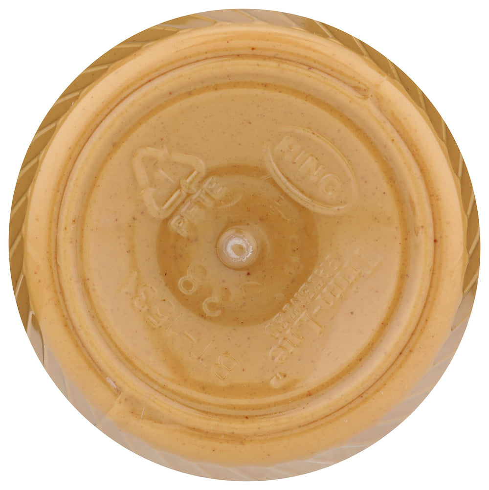 Scoop of creamy peanut butter spread showcasing smooth texture