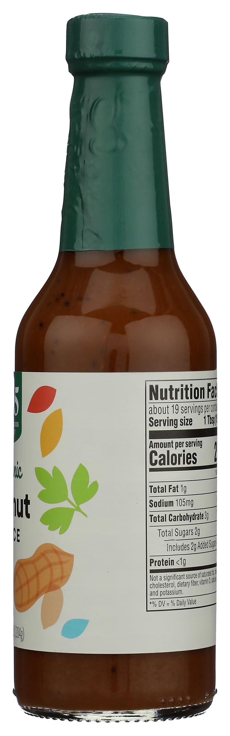 Glass bottle of 365 by Whole Foods Market Organic Peanut Sauce with fresh peanuts nearby.