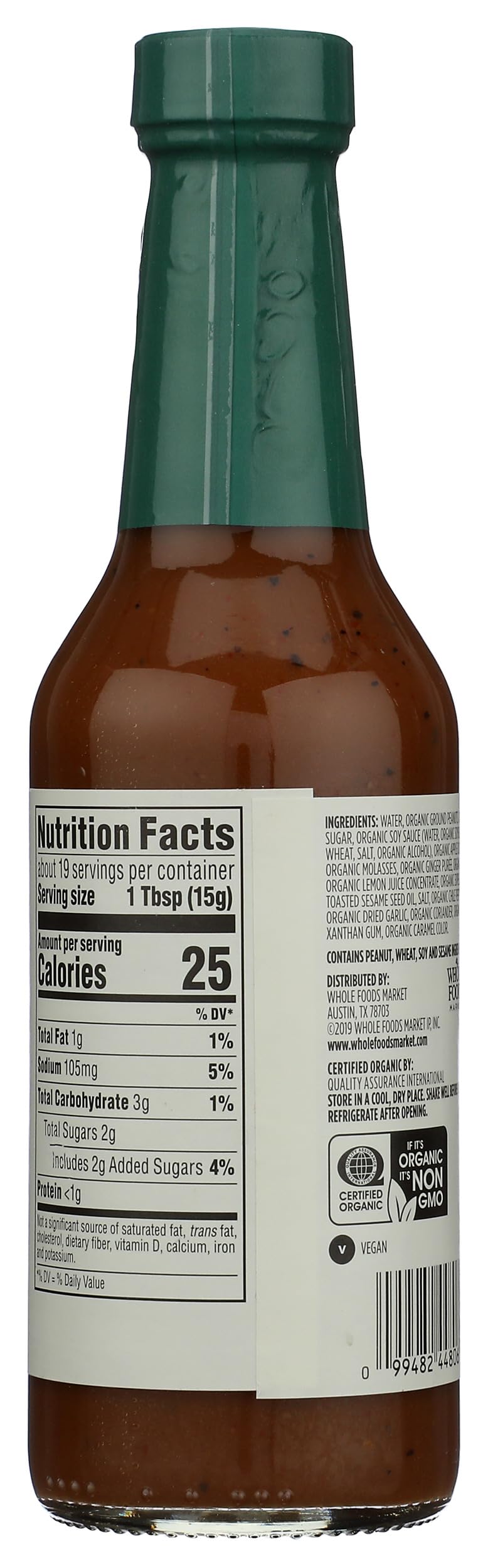 Pouring 365 by Whole Foods Market Organic Peanut Sauce over noodles for a quick flavor boost.