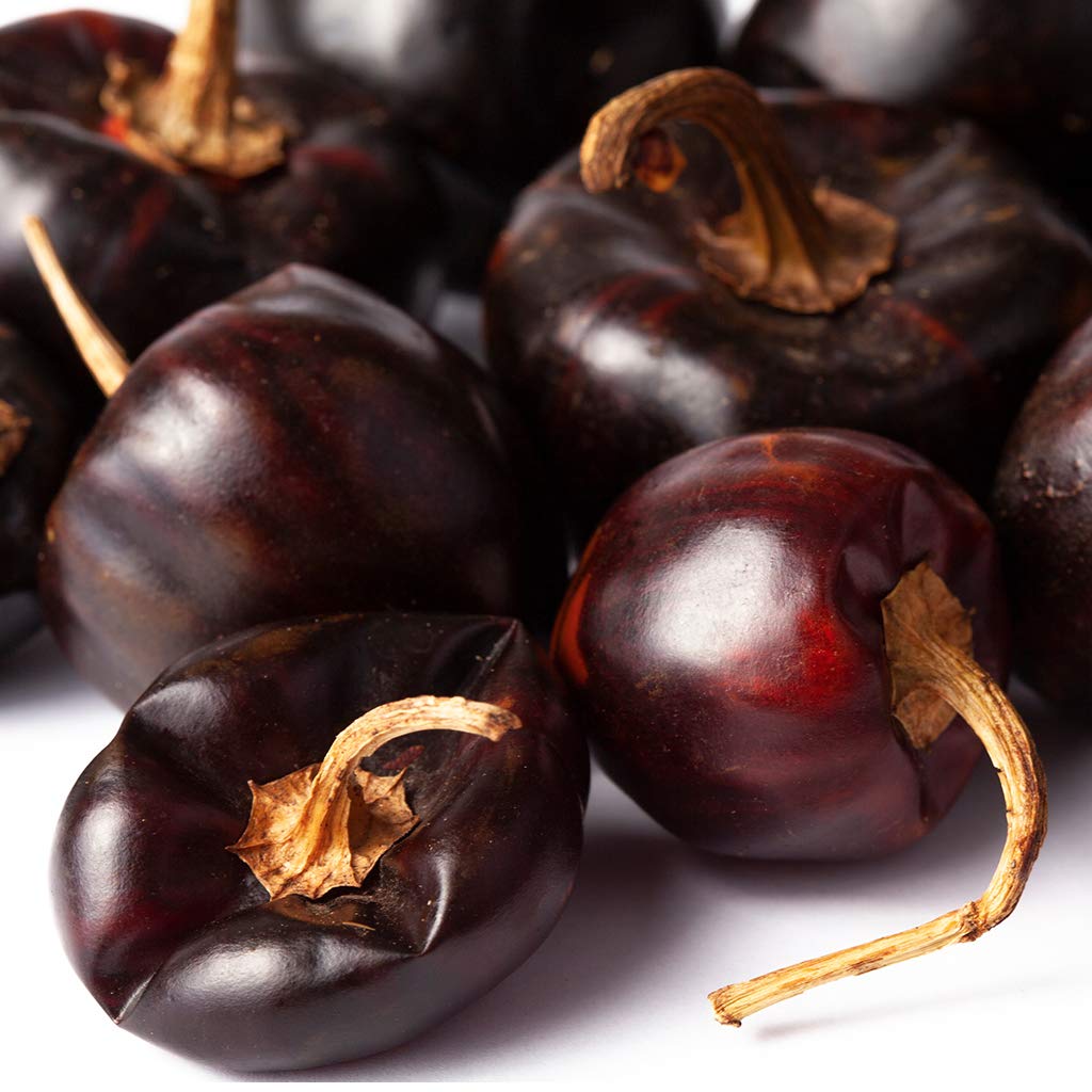 Close-up of 777Spices Cascabel peppers showcasing glossy skins and subtle smokiness