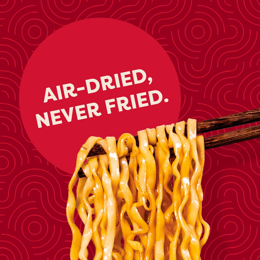 Noodles in bowl with toppings, showcasing plant-based protein and vibrant flavors.