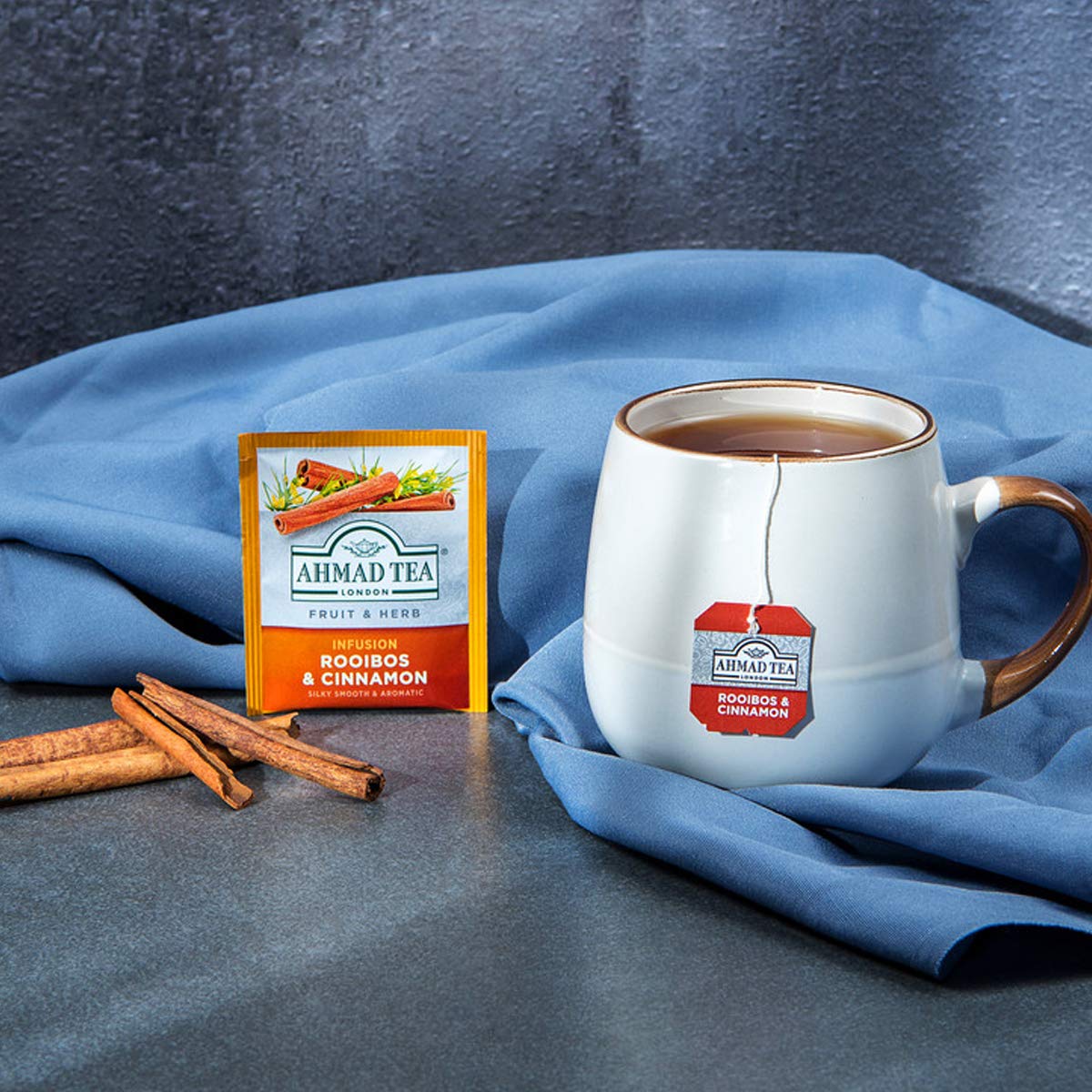 Ahmad Tea Rooibos Cinnamon steeped cup releasing warm, inviting aroma.