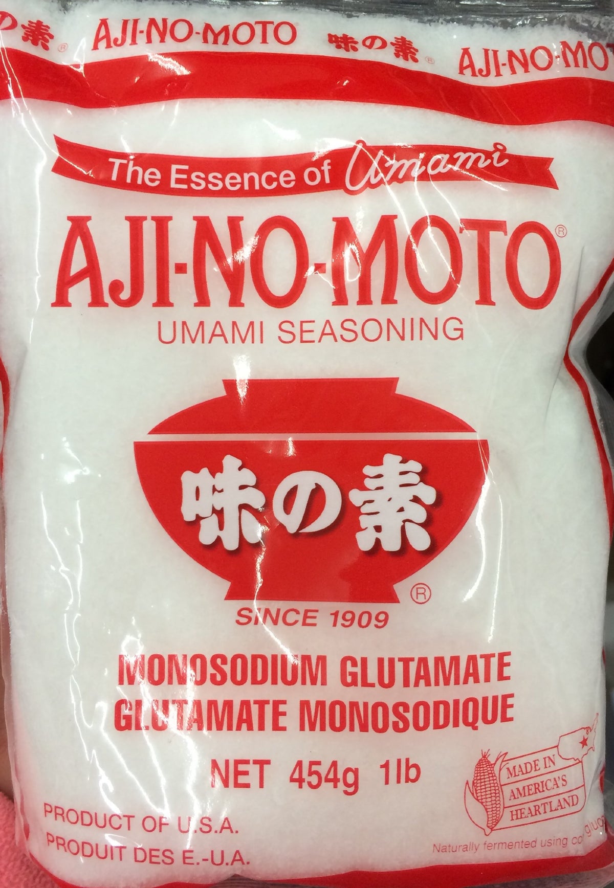Ajinomoto 16oz umami seasoning bottle enhances savory depth in meats and vegetables.