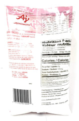 Ajinomoto umami seasoning scoop beside jar for easy flavor boosting.