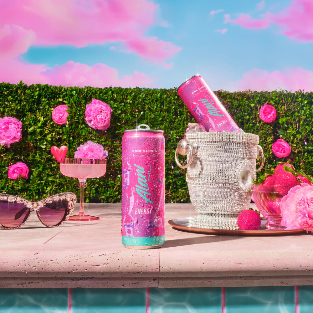 Alani Nu Pink Slush outdoors with can, ready for on-the-go energy