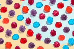 Albanese mixed berry gummies featuring cherry, strawberry, grape, blue raspberry visuals.