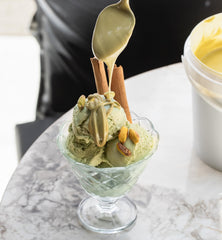 Label close-up on Alkis Pistachio Cream airtight bucket.