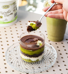 Pour shot of Alkis Pistachio Cream for chocolate and desserts.