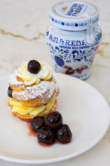 Two-pack Amarena Fabbri cherries in syrup on a dessert plate.