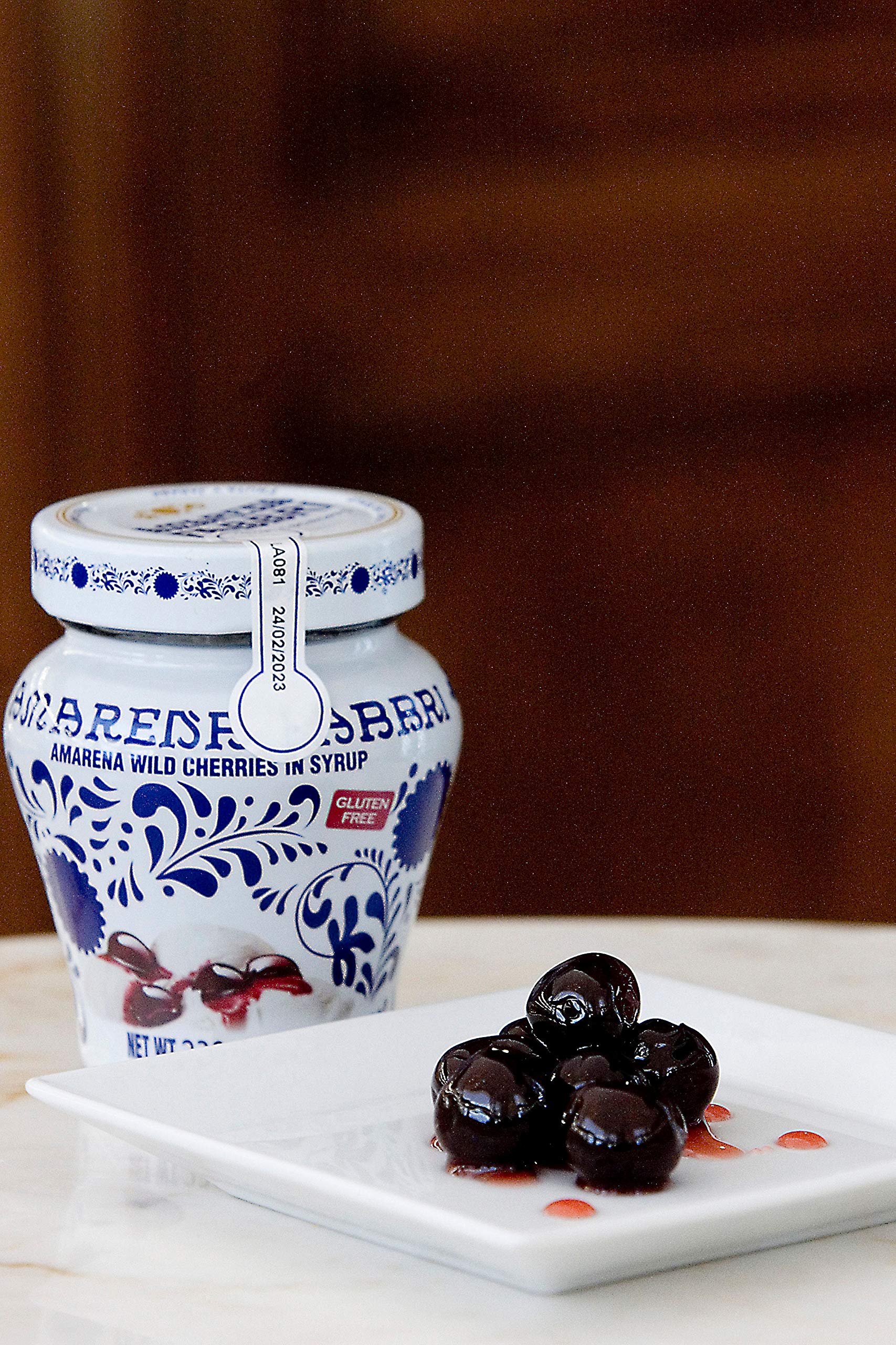 Close-up of Amarena Fabbri cherries atop gelato, an elegant topping.