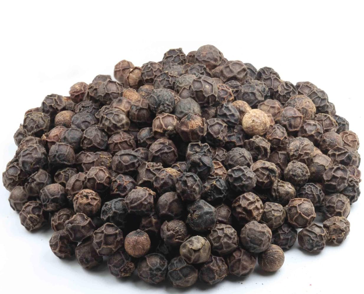 Whole Tellicherry peppercorns pour from Amazon Grocery bag over dishes.