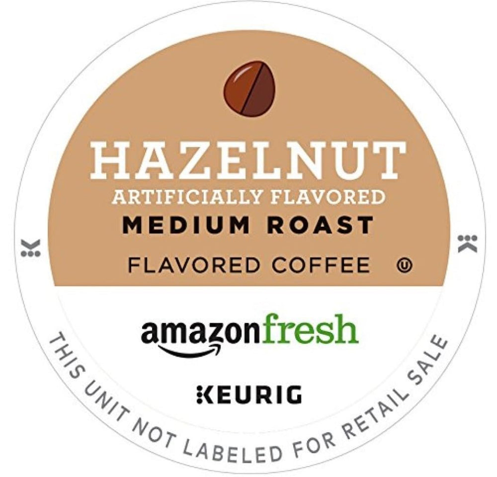 Close-up of AmazonFresh hazelnut K-Cup pod highlighting premium Arabica beans.