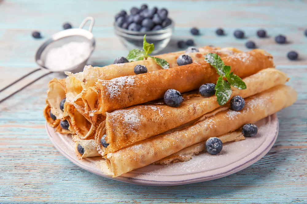 Nonstick pan cooking delicate crepes with American Table mix.