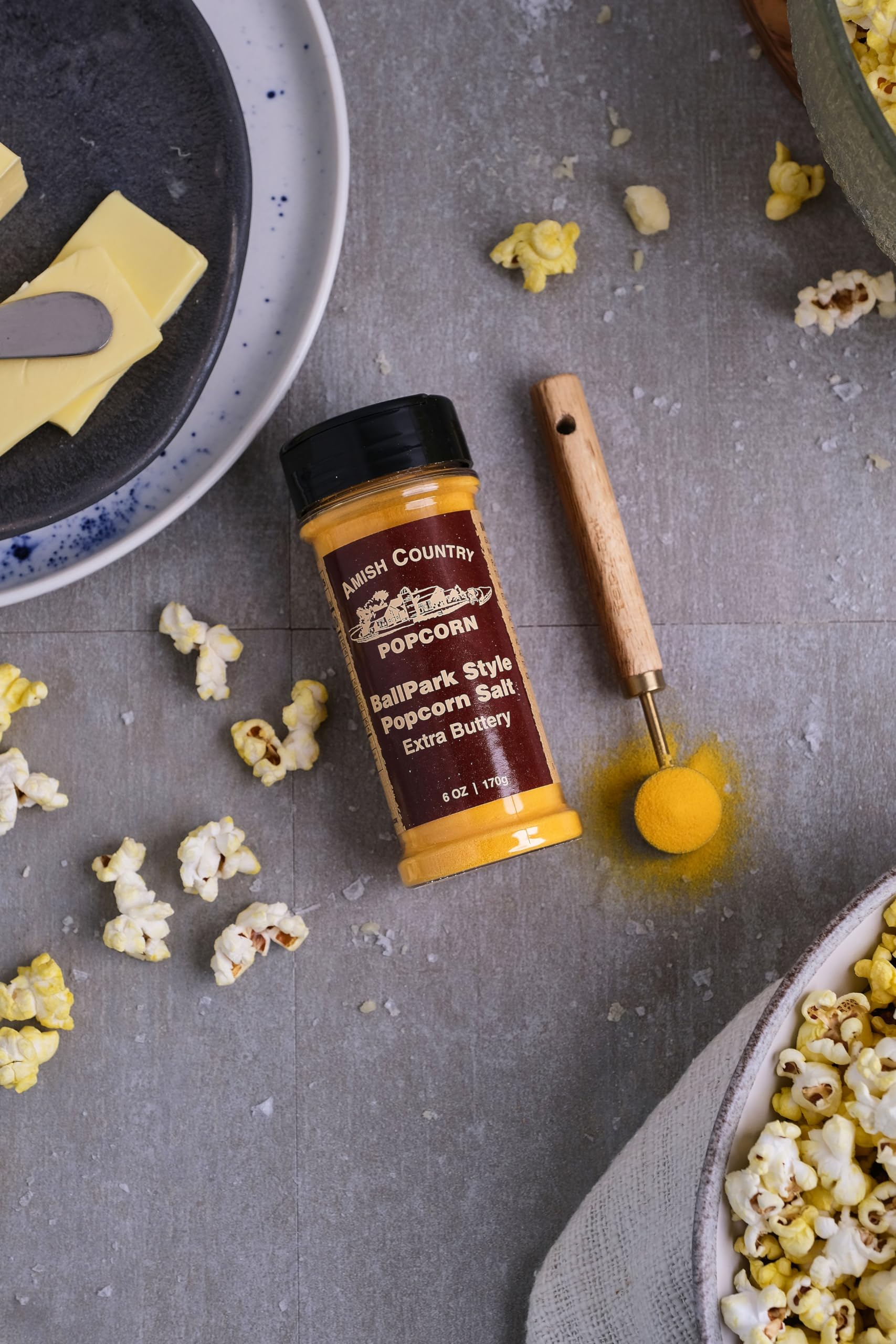 Amish Country Popcorn Ballpark ButterSalt seasoning a steaming bowl of popcorn.