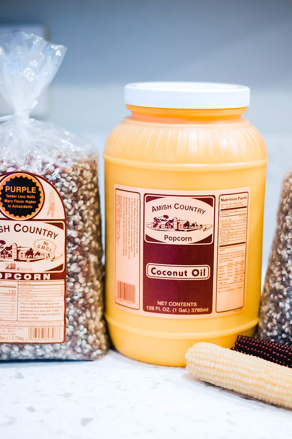 Amish Country Popcorn coconut oil bottle pour demonstrates easy, even coating for fluffy popcorn