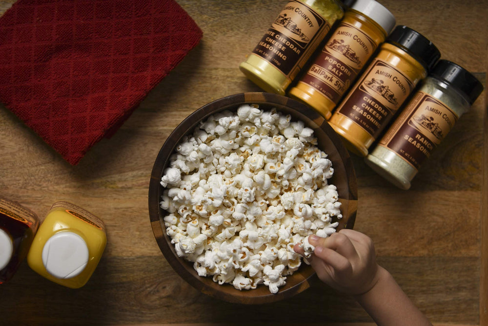 Amish Country Popcorn family enjoying a bowl during a cozy night.