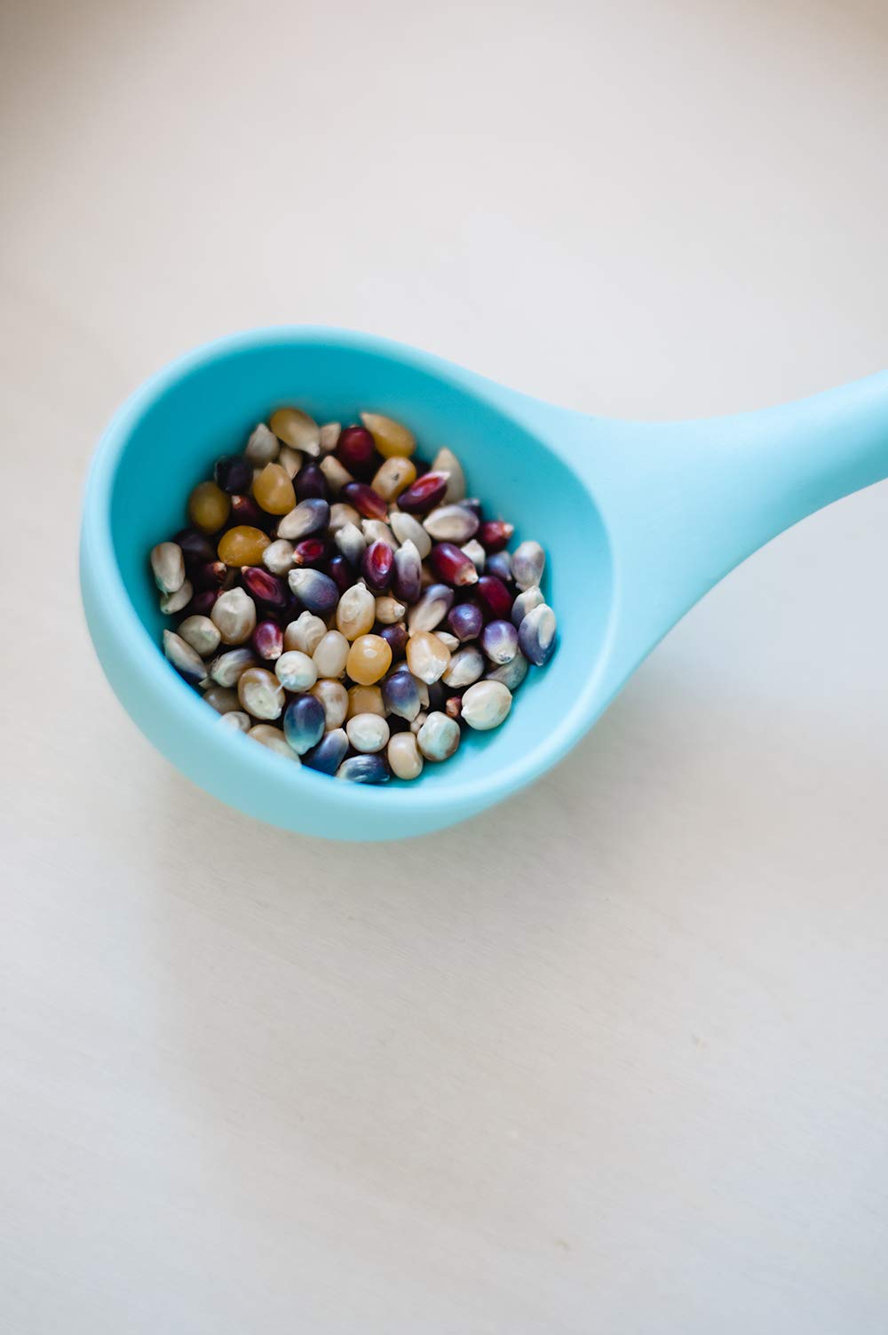 Popped rainbow popcorn in a crisp, colorful bowl.