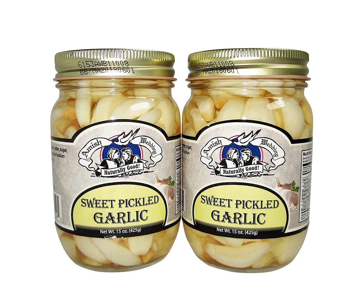 Amish Wedding sweet pickled garlic in two jars, ready to elevate antipasti and sauces.