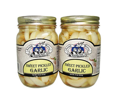 Amish Wedding sweet pickled garlic in two jars, ready to elevate antipasti and sauces.