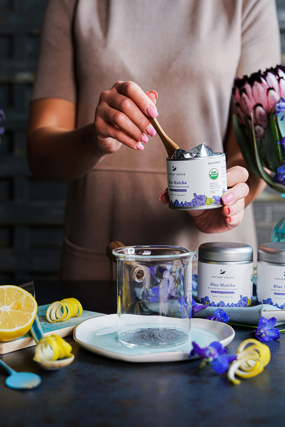 Ancient Choice blue matcha tin canister on shelf highlights sustainable, reusable packaging.