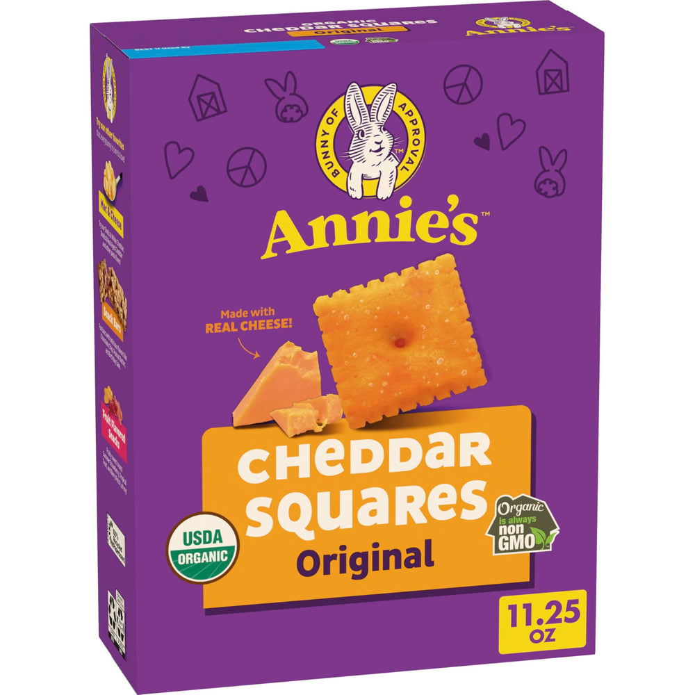Annie's Organic Original Cheddar Squares box on a kitchen counter, ready for snacking.