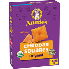 Annie's Organic Original Cheddar Squares box on a kitchen counter, ready for snacking.