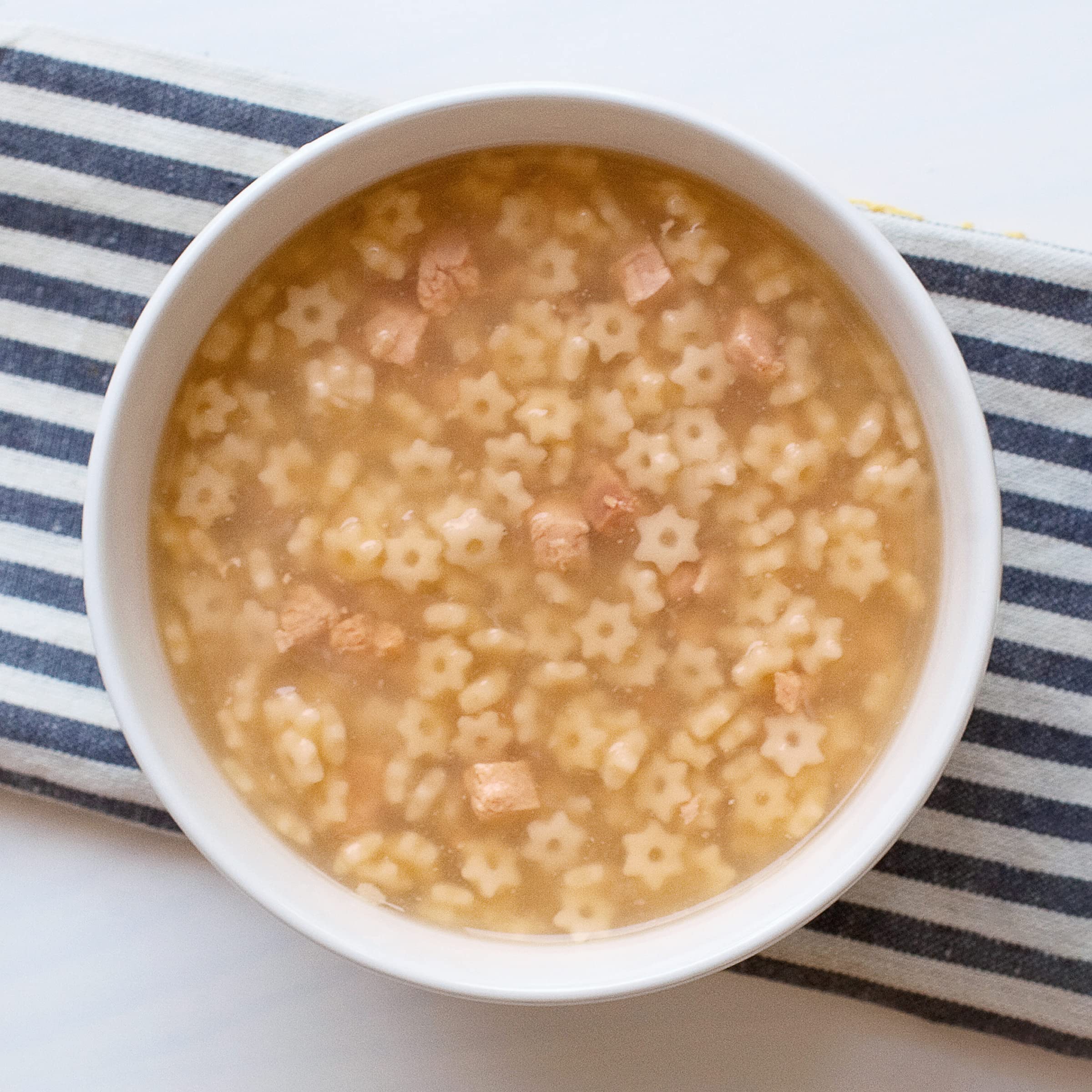 Annie’s Organic Star Pasta Chicken Soup chicken chunks close-up, protein-rich and satisfying.