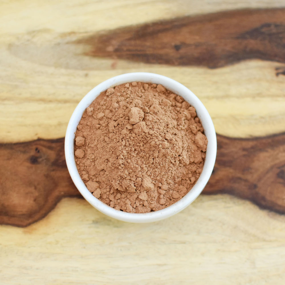 Oatmeal bowl dusted with Anthony's Cocoa Powder for warmth.