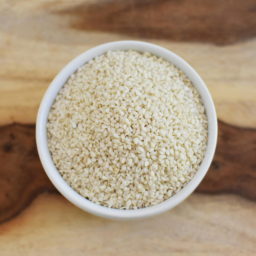 Anthony's Organic Hulled Sesame Seeds hand pouring shot suggests easy topping and flavor boost