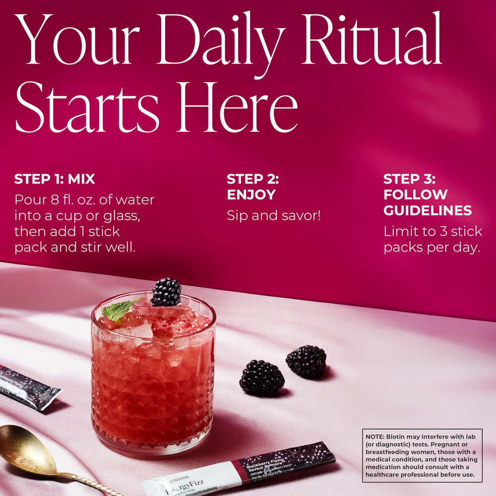 Arbonne Energy Sticks dissolving in water with bright fizz.