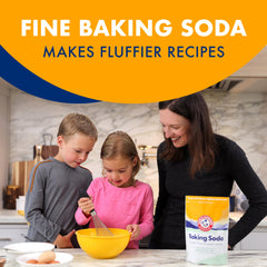 Pouring Arm & Hammer Baking Soda into a mixing bowl for baking