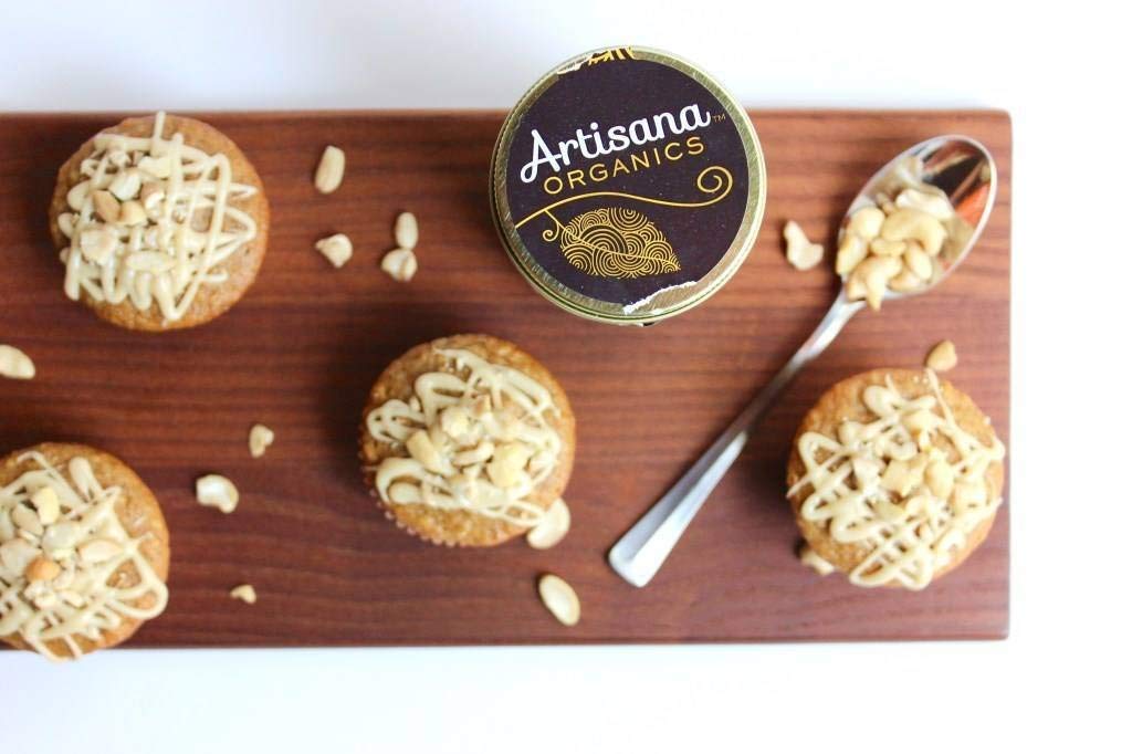 Artisana Almond Butter spread with a knife shows creamy texture and richness.